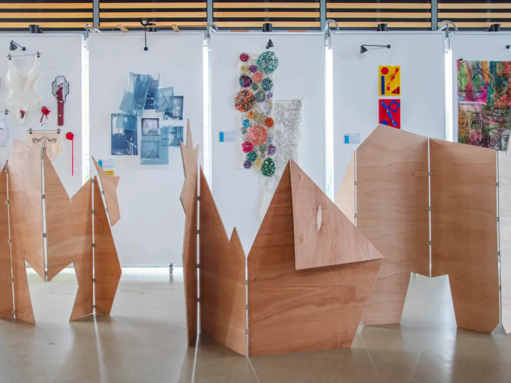 Interior shot of Folly campus atrium featuring plyboard structural artwork in the foreground