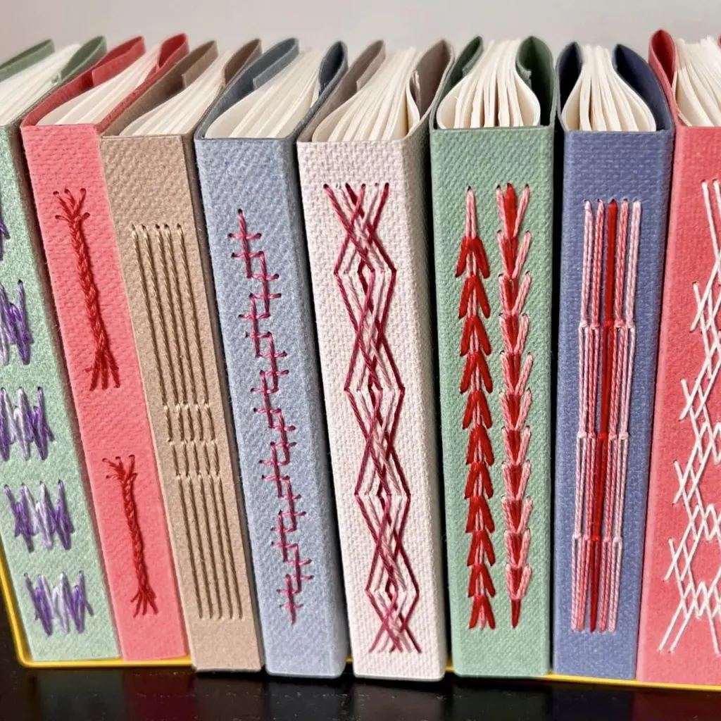 A line of books with decorative stitched binding