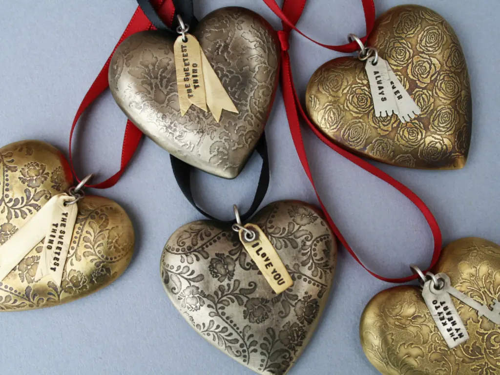 A collection of etched metal Christmas decorations.