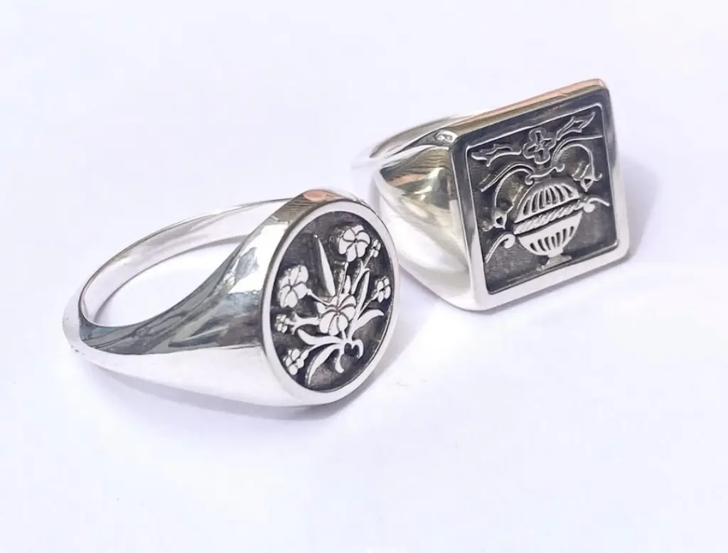 Two silver rings with custom sigils
