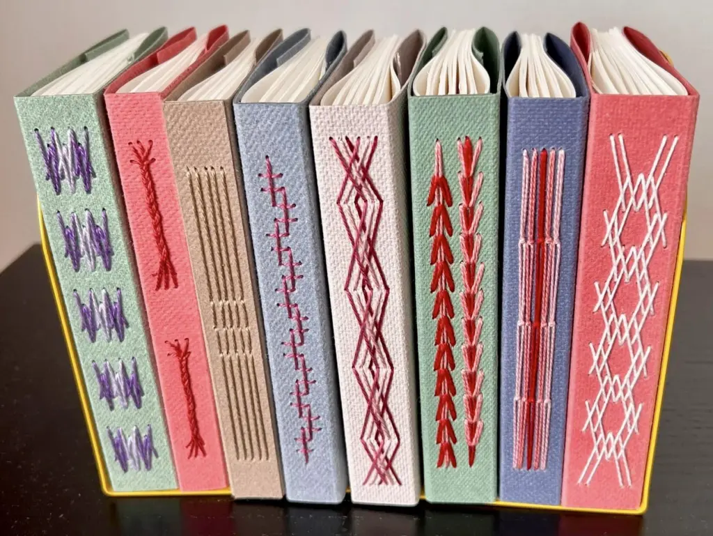 A line of books with decorative stitched binding