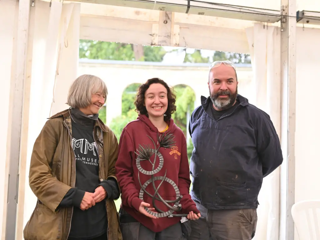 L to R – Lesley Greene, co-ordinator of Earth Fire Iron, Neve Taylor-Bridges holding the maquette of her sculpture, Adam Greenwell AWCB LWCB.