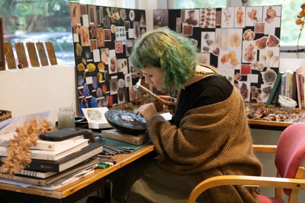 Ren Garside practicing repousse copper work (photo: Oliver Cameron-Swan)